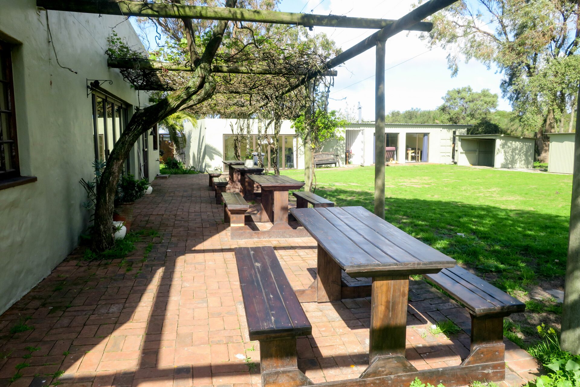 Outdoor picnic tables beneath a pergola